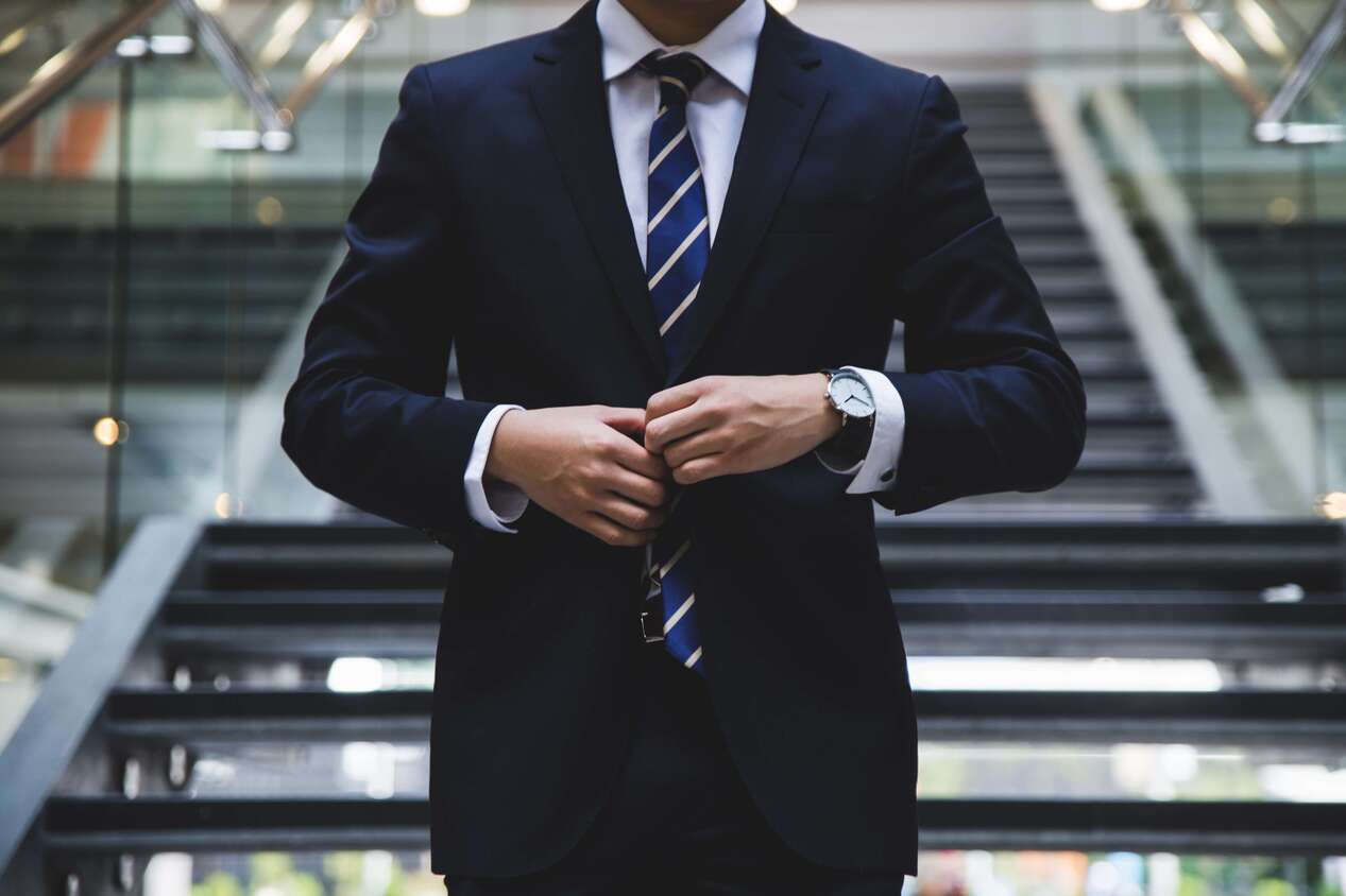 man in suit down the stairs